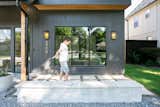 A boy plays in front of the RAM picture window with grids.
