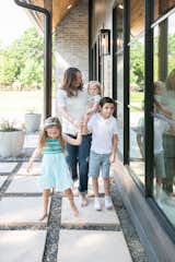 A family enjoys this Dallas area home featuring RAM picture windows on the front facade.