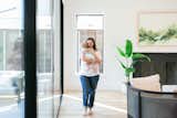A mother and her child enjoy the natural light provided by the large RAM sliding door and picture window in the living room of this Dallas area home.