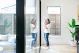 A mother and her child enjoy the natural light provided by the large RAM sliding door and picture window in the living room of this Dallas area home.
