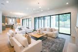 RAM aluminum sliding doors illuminate the open-concept living and kitchen areas.
