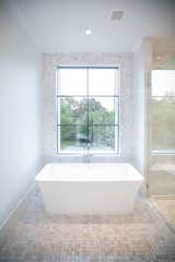 RAM picture windows bring natural light into this clean and airy bathroom space.