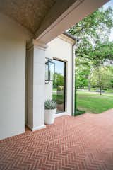This Spanish Mission style home in Highland Park, Dallas, features large RAM picture window to welcome its guests into its airy and open entrance.