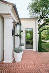 This Spanish Mission style home in Highland Park, Dallas, features large RAM picture window to welcome its guests into its airy and open entrance.