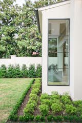 RAM picture windows with modern aluminum grids bring the outdoor scenery inside to this master bedroom area.