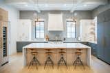 RAM aluminum casement windows provide natural light into this modern style kitchen inside a remodeled Houston-area home.