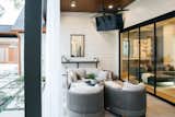 RAM picture window with aluminum frame adds a warm yet modern touch to this traditional style remodeled Houston back porch.