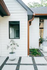 RAM picture window with aluminum frame adds a warm yet modern touch to this traditional style remodeled Houston area home backyard.