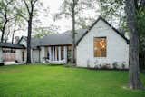 RAM large picture window with aluminum frames add a warm yet modern touch to this traditional style remodeled Houston area home backyard.