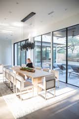 This living and dining spaces is opened up to the outdoor view with RAM picture windows and sliding door.