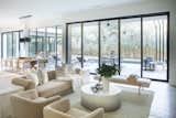 This living and dining spaces is opened up to the outdoor view with RAM picture windows and sliding door.