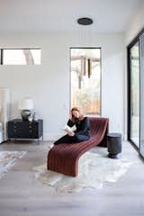 This reading nook is opened up to the outdoor view with RAM picture windows and sliding door.