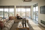 Warm light streams into this living space from RAM picture windows and sliding door.