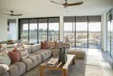 Warm light streams into this living space from RAM picture windows and sliding door.