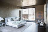 RAM two-panel sliding door brings the outdoors into this earthy master bedroom.