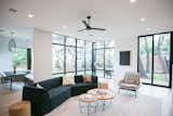 RAM sliding door and picture windows allow natural light to stream into this modern and bright living room.