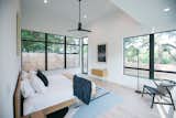 RAM picture and casement windows create a seamless transition between this master bedroom and the outdoor pool area.