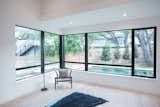 RAM picture and casement windows create a seamless transition between this master bedroom and the outdoor pool area.