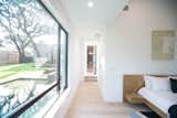 RAM picture and casement windows allow for light and a cool breeze to enter this modern master bedroom.