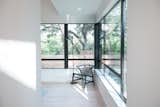 RAM picture and casement windows allow for light and a cool breeze to enter this modern master bedroom.