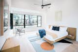 RAM picture and casement windows allow for light and a cool breeze to enter this modern master bedroom.