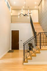 RAM picture windows allow natural light to pour onto this wooden staircase.