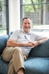 Renowned Dallas-area builder, Greg Alford, sits in front of RAM picture windows in this gorgeous home.