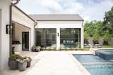 This backyard pool oasis in the heart of Dallas opens seamlessly into the home through RAM picture windows with modern grids.