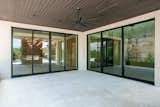 RAM sliding doors create a grand and welcoming entrance to this back porch area.