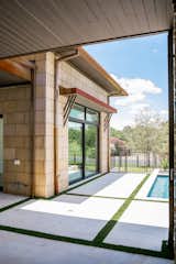 RAM sliding doors create a functional and welcoming entrance to this backyard pool area.