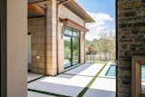 RAM sliding doors create a functional and welcoming entrance to this backyard pool area.