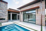 RAM sliding doors create a functional and welcoming entrance to this backyard pool area.