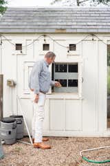 Builder, Christopher Garrett, checks the hen house for new eggs at White Box Farm.