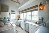 This cozy farmhouse style kitchen corner is made complete by RAM white aluminum picture windows.