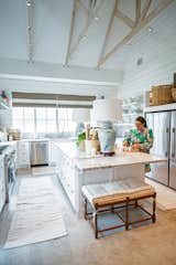 This bright farmhouse kitchen with high ceilings and shiplap is made complete by the aluminum white RAM windows with classic grids. Nicole Garrett of Garrett Custom homes enjoys making eggs that she collected from her hens in this open-concept kitchen.