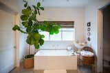 This unique RAM white picture window with diamond grids fills this country chic bathroom with natural light.