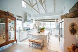 This bright farmhouse kitchen with high ceilings and shiplap is made complete by the aluminum white RAM windows with classic grids. 