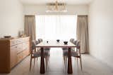 The table legs were designed to break any notion of formality. The gesture of the legs peeping through the table top to make sure their presence does not go unnoticed. 
