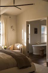 Primary bedroom leading into the primary bathroom with a tub. 