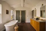 Primary bathroom with full shower and toilet behind the glass doors.