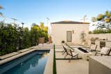 Outdoor pool area with a view of the guest house entrance. 