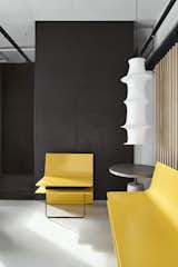 Reception and waiting :

As the reception area serves as the initial point of contact. What makes this sight intriguing is the fact that the yellow metal benches, weighing approximately 600 kg, are beautifully balanced by sleek, delicate metal rods on the other end. This intentional paradox is designed to entice curious observers. In addition, a louvred partition is positioned behind these metal benches to serve as a sliding screen, discreetly shielding the discussion zone from guests waiting outside.