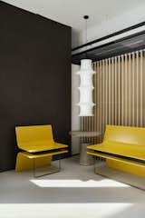 Reception and waiting :

As the reception area serves as the initial point of contact. What makes this sight intriguing is the fact that the yellow metal benches, weighing approximately 600 kg, are beautifully balanced by sleek, delicate metal rods on the other end. This intentional paradox is designed to entice curious observers. In addition, a louvred partition is positioned behind these metal benches to serve as a sliding screen, discreetly shielding the discussion zone from guests waiting outside.