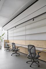 Workstations :

Besides the birch plywood furniture, another anchor point for the design was the thin, easily overlooked metal strip lighting above the workstations. This lighting provided ambient illumination, casting a soft glow that mimicked the natural daylight washing over the ceiling.