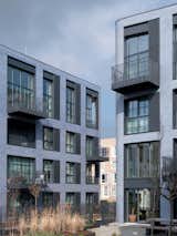 Coworking courtyards and semi-public foyers connect to the urban context.