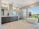 Primary Suite Bath with Spacious Triple-Showerhead Walk-in Shower, Freestanding Tub with Breathtaking Ocean Vistas, and Dual Sink Vanities