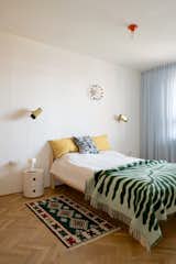 In the bedroom there are two bedside Kartell Componibili storage units designed by Anna Castelli Ferrieri in 1967. On the wall there are two vintage Örsjö Belysning lamps designed by Kjell Blomberg in the 1970s. Artemide Teti lamp in orange designed by Vico Magistretti installed on the sealing with the large Airam bulb. A Serbian kilim rug was bought in the local Kalenić market. Portable Flos Bellhop lamp can be taken in any place in the apartment, but mostly used in the bedroom.