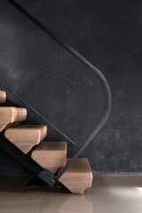 Detail view of the white oak treads at the base of the feature stair as it gently touches down to meet the concrete floor.