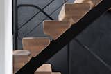 Detail view of the feature stair. The solid white oak treads appear to float in succession - this illusion is reinforced by blending the stair structure with the charcoal backdrop.