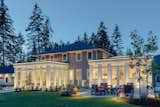 Showcasing both Orangery additions from the backyard with modern landscaping accents.